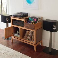 an entertainment center with record players and speakers