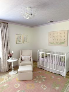 a baby's room with a white crib and pink carpeted flooring