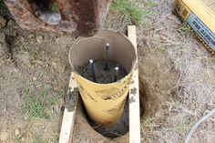 a bucket filled with dirt sitting on top of a field