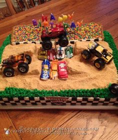 a birthday cake made to look like a race car track with cars on the track