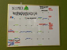 a white board with christmas decorations on it and the date is december written in red