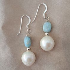 Stunning 925 Sterling Silver Larimar Earrings Pearl Earrings One of A Kind Dolphin Stone and Pearl Earrings Carribean Larimar and Pearl Earrings 925 Sterling Silver One of a kind Statement Earrings with Beautiful Larimar and Large Gorgeous White Pearls Beautiful Dominican Republic Larimar (Pectolite)   It is also called Dolphin stone and only found in The Dominican Republic. The Larimar compliments Pearl so well. These Pearls are beautiful large, white 10mm Fresh Water White Pearls They have Ste Elegant White Larimar Jewelry, White Larimar Gemstone Jewelry, Handmade White Larimar Jewelry, White Larimar Round Jewelry, Silver Larimar Dangle Jewelry, Sterling Silver Dangle Pearl Earrings With Natural Stones, Silver Pearl Earrings With Natural Stones As Gift, Blue Larimar Dangle Earrings, Silver Larimar Dangle Earrings