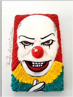 a close up of a cake with a clown face on it