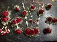 red roses and pearls are laid out on a table