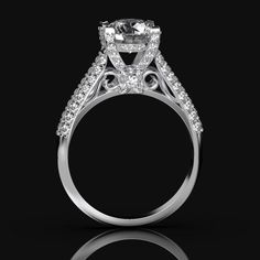 a white gold ring with an oval cut diamond surrounded by smaller round diamonds on the sides