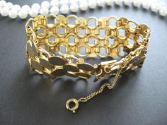 "Gold Chain Link Tuscany Bracelet  > Four strand gold circular link flat bracelet >Featuring articulated links and circles.  > Fold-over clasp > Security chain > No Marking  > Minor age wear... vintage, no noticeable defects This is a nice well made appealing bracelet.  Thanks for looking  vintage sells \"as is\"" Vintage Gold Bracelet With Chain, Vintage Metal Bracelets With Gold Chain, Vintage Gold Chain Bracelet With Oval Links, Vintage Gold Chain Metal Bracelet, Vintage Oval Link Gold Chain Bracelet, Vintage Oval Link Chain Bracelet, Vintage Round Chain Bracelet, Vintage Gold Link Chain Bracelet, Vintage Gold Bracelet With Clasp