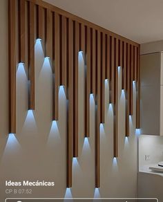 a bathroom with wooden slats and lights on the wall