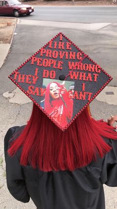 a woman with red hair wearing a graduation cap that says, life is providing people wrong they do what they say can't