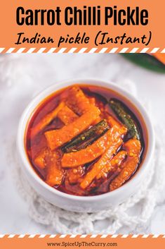 a white bowl filled with food sitting on top of a table next to carrots