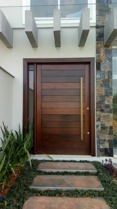 a wooden door in front of a house