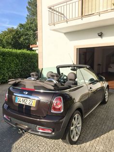 a small car parked in front of a house