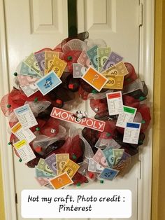 a wreath made out of dollar bills on the front door with monopoly stickers attached to it