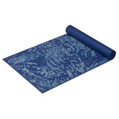 a blue yoga mat rolled up on top of a white surface with an abstract pattern