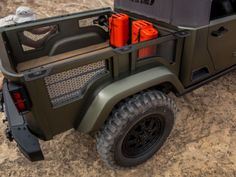 the back end of a green and black golf cart with two coolers on it