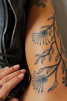 a woman's arm with tattoos on it