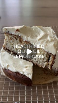 a cake with white frosting sitting on top of a cooling rack