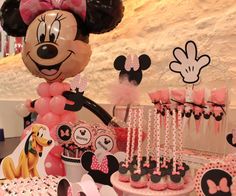 a minnie mouse birthday party with pink and black decorations