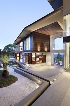 the interior of a modern house with large windows and water feature in the courtyard area