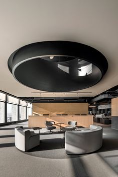 an office lobby with circular seating and large windows