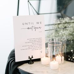 a table topped with candles next to a sign that says until we meet again on it