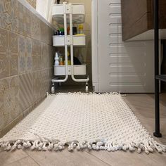 a bathroom with a white rug on the floor