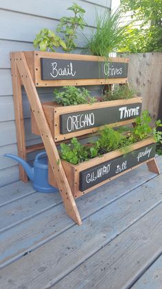 three tiered garden planter made out of wooden pallets with plants growing in them