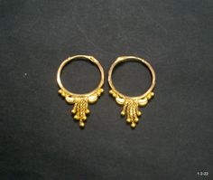 Vintage 18kt gold earrings earring pair from rajasthan india. great handmade design good for jewelry collection. It can be wear in nose as well. Note - please check pictures carefully for more details. Size - 2.8/1.8 cm. Weight - 1.960 grams. Metal - 18kt yellow gold. Round Tilla Earrings For Puja, Traditional Festive Brass Hoop Earrings, Traditional Brass Hoop Earrings For Festivals, Traditional Gold Cutdana Earrings, 22k Gold Cutdana Earrings For Puja, Traditional Yellow Gold Cutdana Danglers, Traditional Gold Plated Cutdana Earrings, Traditional Yellow Gold Danglers With Cutdana, Festive Temple Jewelry Brass Hoop Earrings