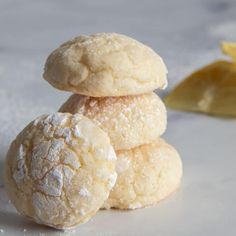 three cookies stacked on top of each other with lemon wedges in the back ground