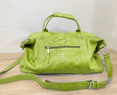 Indulge in the exquisite craftsmanship of our handmade SNAKESKIN Weekender/Duffle bag.  With a focus on premium quality, this travel companion boasts a removable shoulder strap for added convenience, making it equally appealing to both men and women. Dimensions: - Width: 55 cm/21.6 in - Height: 36 cm/14.1 in - Depth: 24 cm/9.4 in Inside, discover a thoughtfully designed interior with a handy zipper pocket. Our commitment to perfection is evident in the rigorous testing each new model undergoes a Luxury Travel Bag With Removable Pouch For Trip, Luxury Shoulder Bag With Removable Pouch For Trips, Luxury Weekender Bag With Removable Pouch, Luxury Travel Bag For Weekend Trips, Luxury Shoulder Bag With Detachable Strap For Weekend Trips, Luxury Shoulder Bag With Removable Pouch For Weekend Trips, Luxury Green Shoulder Bag For Travel, Luxury Green Travel Bag For Daily Use, Luxury Green Travel Bag For Everyday Use