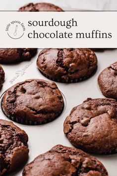 chocolate muffins sitting on top of a baking pan with the words sourdough chocolate muffins above them