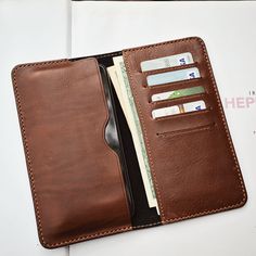 We are Mino Crafts- the Handmade Leather shop. All products are made by Vietnamese skilled craftsmen.  We accept custom orders and wholesale also.  Please visit and contact us on Etsy: https://www.etsy.com/shop/MinoCrafts  #LeatherWallet #LongLeatherWallet #HandmadeLeatherWallet #giftsformen #giftsforher Bifold Wallet With Mobile Phone Bag For Everyday Use, Brown Wallets With Hidden Phone Sleeve, Brown Bifold Wallet With Hidden Phone Sleeve, Bifold Wallet With Hidden Phone Sleeve For Daily Use, Wallet Minimalist, Leather Long Wallet, Checkbook Wallet, Handmade Leather Wallet, Sewing Leather