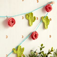 crocheted cactus decorations hanging on a string