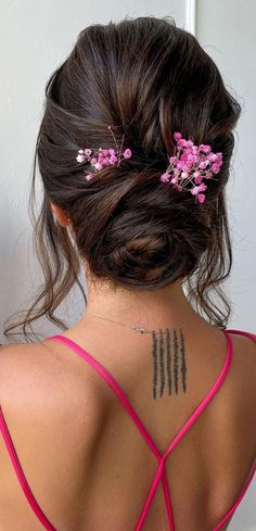 22. Messy Rosebud Bun with Pink Flowers We don’t know about you, but we’re kind of over updo hairstyles, especially hot warmer seasons are... Messy Bun For Short Hair, Short Hair Bun, Long Hair Wedding Styles