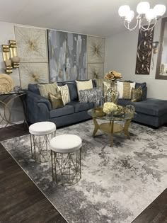 a living room filled with furniture and decor on top of a hard wood floored floor