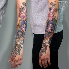 two people with tattoos on their arms and hands, one holding the other's hand