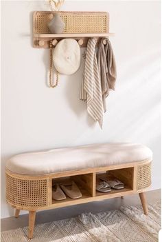 a wooden bench sitting next to a wall filled with shoes and scarves on top of it