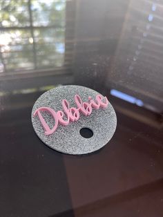 the word dolcera is made out of glitter and pink letters on a black surface