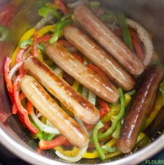 hot dogs and peppers cooking in a pot