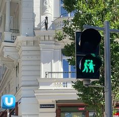 a traffic light that is green with people walking on it