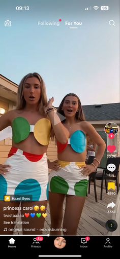 two women in bathing suits standing next to each other on a wooden deck with texting below