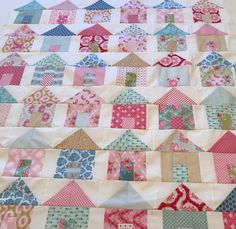 a quilted table runner with houses on it