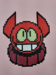 a red and black beaded character with big eyes