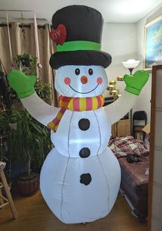 a large inflatable snowman with a top hat and scarf