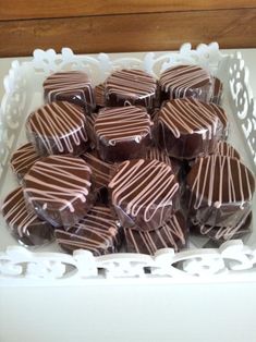 a white tray filled with chocolates on top of a table