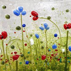 some red, white and blue flowers are in the water with bubbles on it's surface