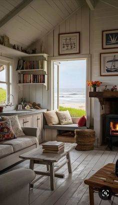 a living room filled with furniture and a fire place in front of a large window