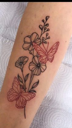 a tattoo with flowers and butterflies on it