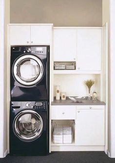 a washer and dryer in a small room next to each other with the door open