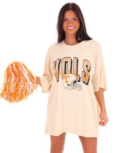 Get your game on with the Vols Helmet Fade Oversized Tee! This officially licensed shirt gives you an old school look while showing your love for the University of Tennessee. With a quirky style and playful tone, this tee is perfect for any true fan. Go Vols! Oversized Fan Apparel Tops For Game Day, Retro Oversized Tops For Game Day, Oversized Retro Top For Game Day, Oversized Screen Print Fan Merchandise Top, Oversized Screen Print Tops For Fan Merchandise, Oversized Graphic Tee For Game Day, Retro Oversized T-shirt For College, Oversized Game Day T-shirt With Screen Print, Oversized Collegiate T-shirt For Game Day