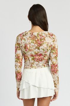 This elegant floral blouse features a v-neckline and long sleeves, providing a sophisticated and timeless look. The ruffle detail adds a touch of femininity, making it the perfect addition to your wardrobe. Stay stylish and comfortable with this versatile piece. Fabric Contents: 93% Nylon, 7% Spandex. Lining: 100% Polyester Made In: USA Skin Dress, Lace Blouse Long Sleeve, Luxurious Fabric, Pink M, Denim Accessories, Feminine Design, Floral Print Blouses, Floral Ruffle, Delicate Jewelry